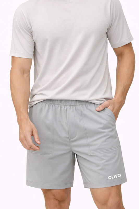 Man wearing a light gray t-shirt and shorts on a white background